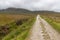 Typical Irirsh farm with road, field and mountains