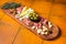 Typical italian antipasto, Cheese and meat plate with Prosciutto ham, Parmesan, Blue cheese, Melon and Olives on wooden