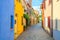 Typical italian cobblestone street with colorful multicolored buildings, traditional houses with green plants in Rimini