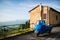 Typical Italian three-wheeler in front of brick house