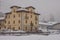 Typical italian villa with closed window blinds or wooden covers in the citiy of Vodo di Cadore during heavy snow