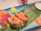 Typical Japanese dish of sushimi and onighiri on a leaf of bamboo