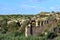 Typical landscape on Sicily with dilapidated ruin in the foreground between wild vegetation