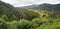 Typical Madagascar landscape at Mandraka region. Hills covered with green foliage, small villages in distance, on