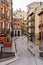 Typical Madrid street winding between buildings with windows and balconies typical of the city