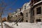 Typical Montreal rowhouses with staircases along a street with heaps of snow on the side