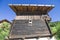 Typical mountain building in stone, white plaster and wood and with colorful flowers