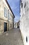 Typical narrow alley paved with cobblestones and with old stone houses in the center of the old town of Guimaraes