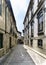 Typical narrow alley paved with cobblestones and with old stone houses in the center of the old town of Guimaraes