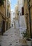 Typical narrow street with decorated stairs leading to apartment in center of Polignano a Mare