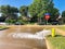 Typical neighborhood area with stop sign near Dallas, Texas, America with open yellow fire hydrant