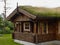 Typical Norwegian wooden mountain cabin log house with turf roof