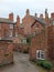 Typical old brick houses with tall chimneys along an alley in chester england