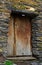 Typical old stone house and wooden door in Ushguli