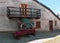 typical outdoor house in mountain with flowerpot with purple flower, blue old wood gig, window and balcony in pragelato italy