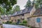 Typical pretty cottages with climbing plants with yellow Cotswold limestone walls in Snowshill, Cotswolds - England