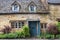 Typical pretty cottages with climbing plants with yellow Cotswold limestone walls in Snowshill, Cotswolds - England