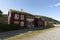 Typical red scandinavian wooden house with grassy roof