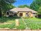 Typical residential house mailbox and blossom bluebonnet wildflower front yard in Dallas, Texas, USA