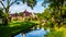 Typical scene of a canal running through the historic village of Midden Beemster