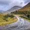 Typical Scottish landscape with heavy clouds and rainbow