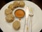 A typical serving of a plate of momo with sesame yellow sauce and red ginger chilli sauce for serve lunch meal to nepali people