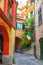 Typical small italian yard with buildings houses, stairs, shutter window and italian flag in Monterosso village, National park Cin