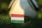 Typical soccer land Hungary and her flag on wooden stick stabbed in grass and backround football ball. World Championship 2022.