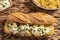 Typical Spanish calamari sandwich with mayonnaise and minced garlic and parsley. A little faded fries and glass of cold beer.