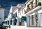 Typical spanish white village houses with flower pots.