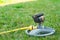 Typical standard diffuser for watering a green young lawn in a private area with a connected water hose