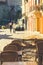 Typical street with cafe tables and golden fall leaves in French village Collioure