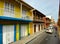 A typical street with cars, buses and motorcycles in the old town portio of Cartagena, Columbia early in a hazy morning