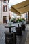 Typical street scene, with cafe tables, local and tourists in Bassano del Grappa, Veneto, Italy