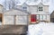 Typical Suburban Detached House with Grey Siding and Red Door