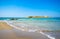 Typical summer image of an amazing pictorial view of a sandy beach and an old white church in a small isl