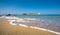 Typical summer image of an amazing pictorial view of a sandy beach and an old white church in a small isl