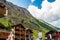 Typical Swiss Wooden chalets amid magnificent mountainsin canton of Valais, Switzerland in summer.