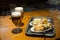 Typical tapa of beer and roasted potatoes in Spain