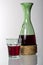 Typical tavern straw bottle and glass with red wine