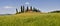 Typical Tuscany landscape, farmland I Cipressini. Italian cypress trees and wheat field with blue sky. Located at Pienza Siena.