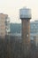Typical ukrainian huge water tower, late autumn misty morning
