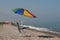 Typical umbrella and chair on spanish rocky beach