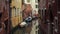 Typical Venice narrow water canal with moored boats, old traditional buildings