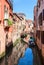 Typical view on the narrow canal in Venice, Italy