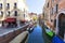 Typical view of the narrow side of the canal, parked boats, Venice, Italy