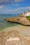 A typical view of rocky beach with clean clear water nearby George Town, Cayman Islands