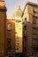 Typical view of street in Naples. Behind several apartment buildings one can see a beautiful dome of the cathedral