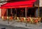 Typical view of street with tables of cafe in Paris, France.