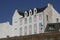 Typical white hotel building with lovely multicolored shutters in Quiberon, closed hotel out of season